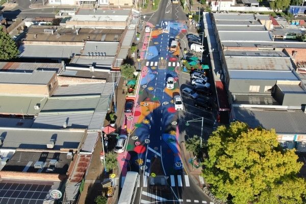 Aerial photo of colourful new street with a beach scene painted on the road