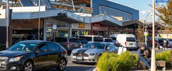 Photo of shops, cars and pedestrians in Noble Park