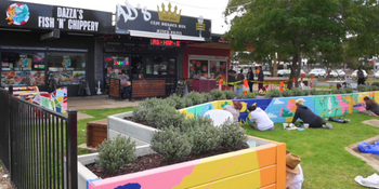 Colourful parklet being painted by community members